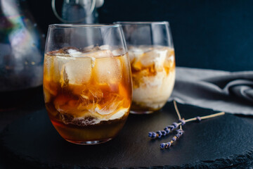 Honey Lavender Cold Brew Latte: Iced coffee with lavender syrup and almond milk over ice cubes