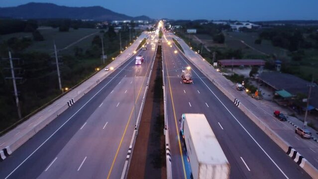Traffic on the main road during evening twilight, Aerial view