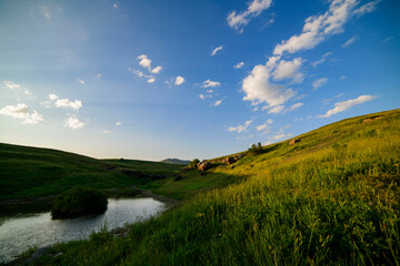Obraz premium Beautiful panoramic landscape sunset over the river and hills.