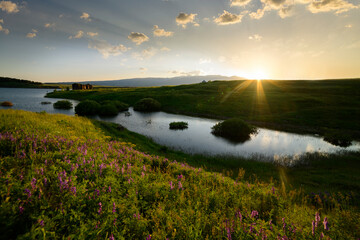 Beautiful panoramic landscape sunset over the river and hills.
