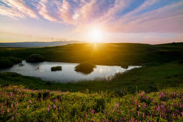 Beautiful panoramic landscape sunset over the river and hills.