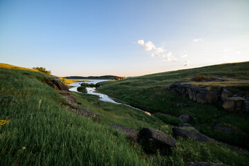 Fototapeta na wymiar Beautiful panoramic landscape sunset over the river and hills.