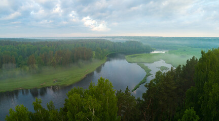 Aerial panoramic landscape with sunset over the river and beautiful clouds on the sky.