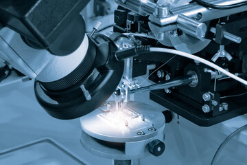 Chip testing equipment. Manufacturing of microchips. A close-up study of a test sample of a...