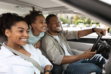 Cheerful Family Driving A Car Having Road Trip, Side View