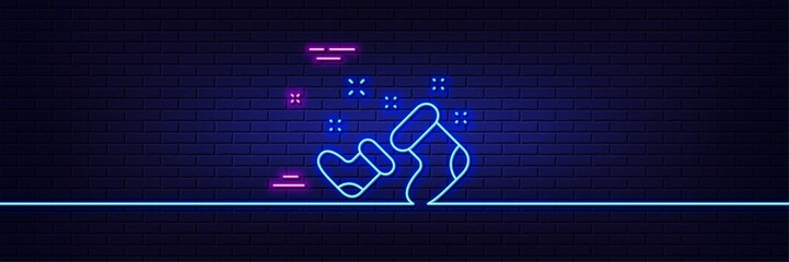Neon light glow effect. Santa boots line icon. Christmas or New year sign. Claus symbol. 3d line neon glow icon. Brick wall banner. Santa boots outline. Vector