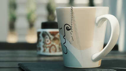 Big cup of tea with small teapot inside