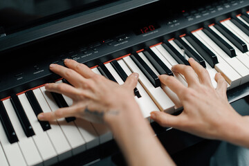 Obraz premium refined woman pianist plays the piano with thin fingers, sensually plays a musical instrument
