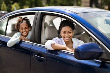 Cheerful Black Mother And Daughter Sitting In New Auto