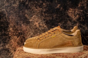 Detail of a pair of high-end brown casual sneakers with the background out of focus