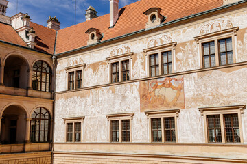 Litomysl, Czech Republic, 17 April 2022: Renaissance castle, UNESCO World Heritage Site, chateau with sgraffito mural decorated plaster at facade at sunny day, medieval historical town, sundial