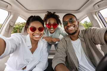 Cheerful African American Family Posing In Car, Wearing Sunglasses