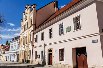 Fototapeta na wymiar Litomysl, Czech Republic, 17 April 2022: narrow picturesque street with medieval colorful gothic merchant houses at sunny summer day, historic renaissance and baroque buildings, medieval church