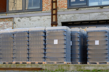 Empty beer bottles in packs stand on the territory of the brewery.