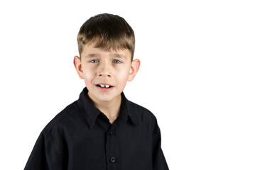 Young boy 6-8 years old in a black shirt on a white background with surprise and a pleasant happy smile. The boy accepts the news with surprise and joy