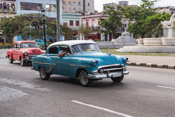 Fototapeta na wymiar baby blue and white classic car on the street of havana cuba
