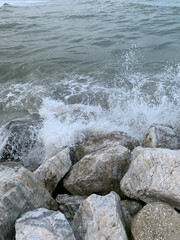 Large stones boulders on the seashore in the evening