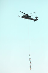 black hawk helicopter lift men out of danger