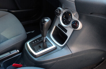 Obraz premium Close up of the automatic gearbox lever, black interior car. Automatic transmission gearshift stick, Closeup a manual shift of modern car gear shifter