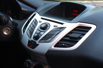Fototapeta na wymiar Modern car dashboard and control buttons. Premium car interior. Smart multimedia system for automobile. Car detailing. Modern car interior details. 
