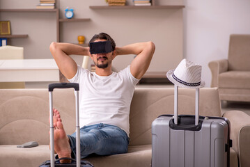 Young man preparing for trip at home