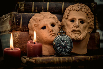Pocket watch and old book, hourglass on dark background. Journey and Learning Concept, Vintage Style.