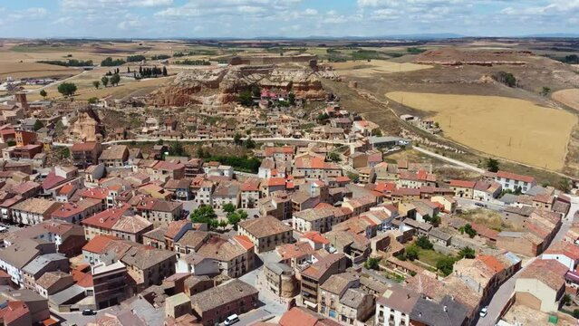 Aerial cinematic perspective of San Esteban de Gormaz situated in province of Soria - Spain. River Duerdo crossing the city. Beautiful architecture with small streets and houses built in the mountains