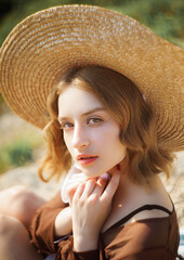 Beautiful portrait of a girl in a straw hat. Vintage tone.