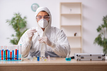 Young male chemist in vaccination concept during pandemic