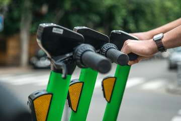 Electric scooters in a city are available for rent. close up.