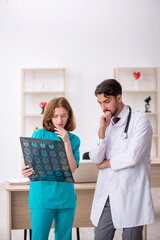 Young male doctor radiologist and female assistant working in th