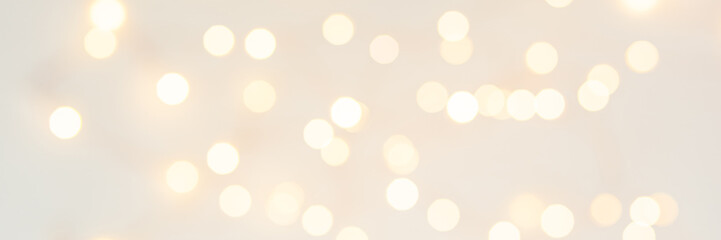 Background with abstract golden sparkling christmas lights. Bokeh effect. Defocused. Template for holiday card. Banner