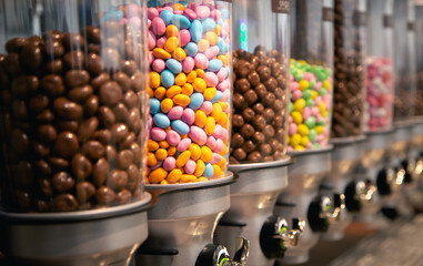Bright candies in containers by weight in a candy store.