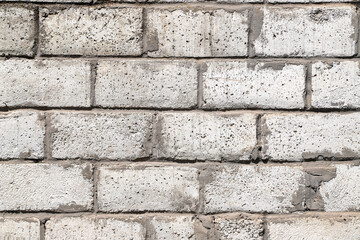 Obraz premium An old white wall made of rough ceramsite concrete blocks as a background