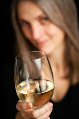 Toasting the wine. A portrait of a mature woman enjoying a glass of wine. Real people, real emotions.