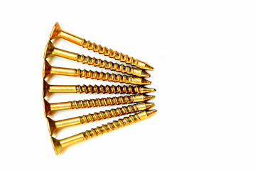 construction screws for wood and metal in gold color on a white background