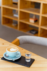Fototapeta na wymiar Cup of hot cappuccino coffee on table