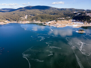Aerial winter view of Dospat Reservoir covered with ice, Bulgaria