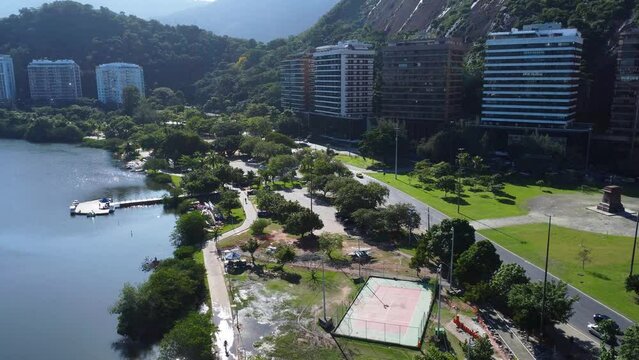 Aerial view of Rodrigo de Freitas Lagoon, south zone of Rio de Janeiro, Brazil. In the background, the beaches of Ipanema and Leblon. Sunny day. Cars traveling on Avenida Epit&aacute;cio Pessoa. Drone take.