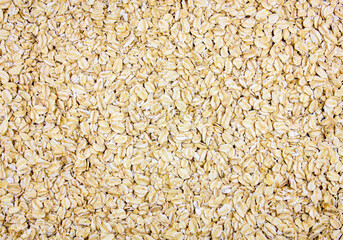 Natural fresh oats. Raw oatmeal background. Oat flakes. Cereal breakfast oats background.
