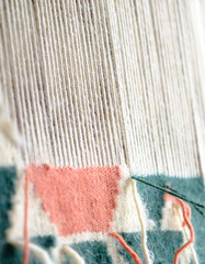 Close up, Detail of loom for weaving traditional handmade carpets, rugs.  Weaving and manufacturing of Turkish style homemade carpets. Selective focus.