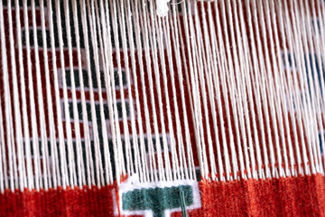 Close up, Detail of loom for weaving traditional handmade carpets, rugs.  Weaving and manufacturing of Turkish style homemade carpets. Selective focus.
