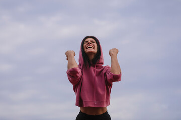 happy person with arms raised. Yes woman. Happy day. Lifestyle. Photo. Sky background. Smile. 