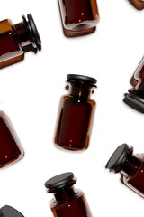 Pharmacy glass bottles with black rubber plug on white background