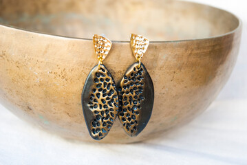 Large black and gold earrings of polymer clay. Fashion jewelry.