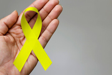 Yellow ribbon. Yellow July, Bone Cancer Awareness Month and Viral Hepatitis - obrazy, fototapety, plakaty