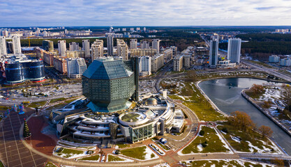 View from drone of rhombicuboctahedron-shaped building of National Library of Belarus on background...