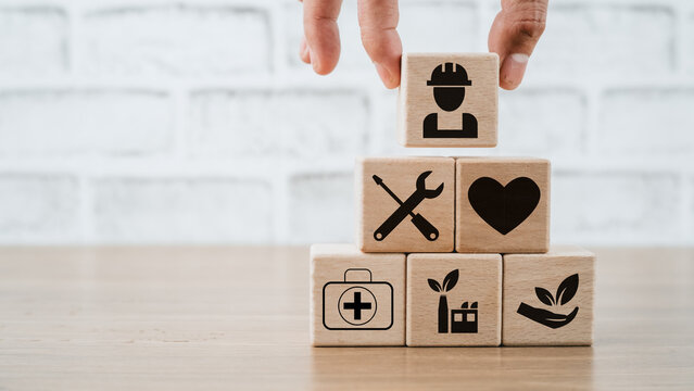 Health safety environment HSE education industry Concept, Man hand holding wooden cube block with Health safety environment icon with copy space.