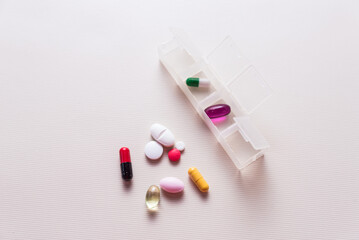 colored pills in a pillbox, medicinal, pandemic, health and wellness concept