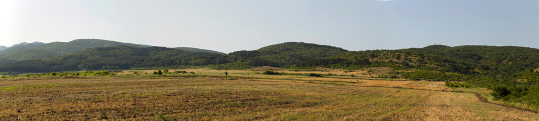 Fototapeta na wymiar Panoramic terrain of southern Europe. Landscape of Bulgaria-mountains, fields, flora.
